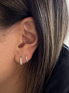 The pavé setting originates from the French word “to pave”—each earring is paved with six diamonds, adding a little extra to your every day stack. If you're looking for something thinner, shop our Pavé Hoop Huggie Earrings.Complete the look with the Petite Hoop Huggie Earrings. Featuring six round diamonds on each earring.Secure snap hinge closure. 14k solid gold—alwaysWeight: Approx 1.1g per earringWidth: 2.3mmCarat weight: 0.24cw per earringClarity: SI 1-2 Earring Stacks, Rib Ring, Ear Piercing Studs, Diamond Huggie Earrings, Fall Rings, French Word, Diamond Huggies, Simple Stud Earrings, Lobe Piercing