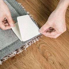 a woman is cleaning the floor with a sponge and cloth on top of an area rug