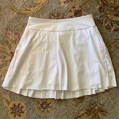 Nwot Kyodan Tennis / Golf Pleated White Skirt With Built In Shorts, Xs White Relaxed Skort With Pockets, White Skirted Bottoms With Pockets, White Tiered Skirt With Pockets, White Skirted Skort With Pockets, White Skirted Skirt With Built-in Shorts, White Flowy Tiered Tennis Skirt, White Tiered Skort, White Tiered Lined Skort, White Lined Skirt With Short Inseam