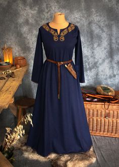 This Early Medieval wool dress is universal for the Vikings and Slavs or any other reenactors. Based on medieval iconography and archaeological finds from Europe. The dress has two wide wedges on the both sides, sewn a few centimetres over the hips. The dress reaches the ground, has a simple body and long tapering sleeves which are sewn to the body at right angles. The dress' circumference is about 2 meters. The split neckline is embellished entirely with hand-embroidered 100% silk thread. Patte Traditional Long Sleeve Dresses For Medieval Festivals, Viking Costume Dress For Medieval Festivals, Traditional Medieval Festival Costume Dresses, Traditional Medieval Dress For Ceremonial Occasions, Traditional Medieval Dress For Ceremonial Use, Traditional Medieval Dress For Ceremonial Events, Historical Dresses For Medieval Festivals, Viking Style Dresses For Medieval Festivals, Historical Dresses For Larp And Medieval Festivals