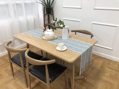 a table with two chairs and a tea pot on it