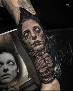 a man's arm with tattoos on it and an image of a woman in the background