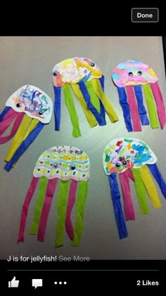 four colorful jellyfish kites on a table