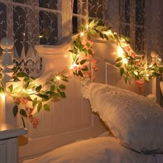 there is a bed with flowers and lights on the headboard