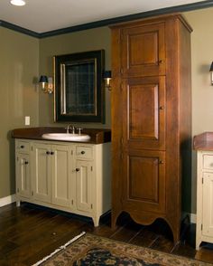 a bathroom with a sink and wooden cabinet next to a rug on the floor in front of it