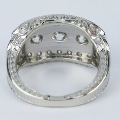 an intricately designed ring with clear stones on the inside and outside, set in white gold