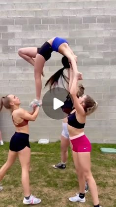 three women doing exercises in front of a brick wall