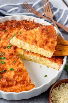 a casserole with cheese and parmesan in a white dish on a table