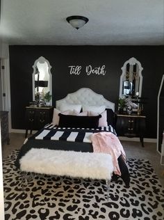 a black and white bedroom with leopard print rug