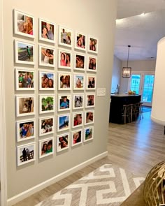 a wall with many pictures on it in a living room next to a dining room