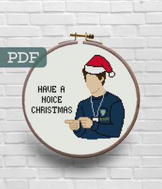 a cross stitch pattern with the words have a nice christmas on it and a man in a