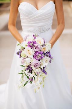 a bride holding a bouquet of flowers in her hands