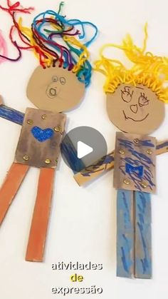 two children made out of cardboard and string