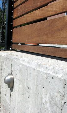 a close up of a concrete wall with wood slats on it and a door handle