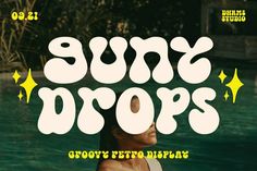 the sun drops font is displayed in front of a swimming pool