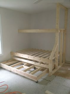 a bed frame is being built in an empty room