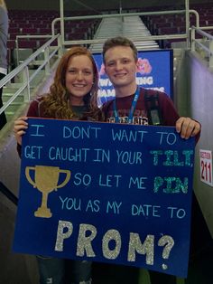 two people holding up a sign that says i don't want to get caught in your prom