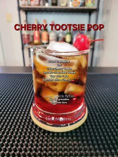 there is a drink with ice and cherries in it