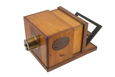 an old fashioned wooden box camera on a white background with clippings to the side