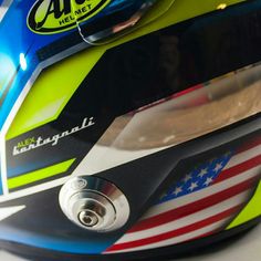 a helmet with an american flag design on the front and side, sitting on top of a table