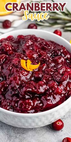 cranberry sauce in a white bowl with orange slices around it and text overlay