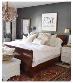 a bedroom with gray walls and white bedding