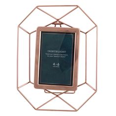 a copper metal frame with a black label on the front and back side, in an octagonal shape