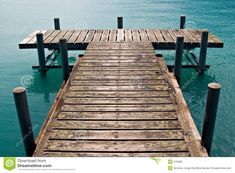 a wooden dock in the middle of some water