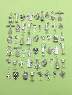 a bunch of silver colored charms on a green background