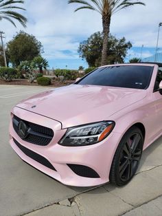 a pink mercedes benz coupe parked in a parking lot