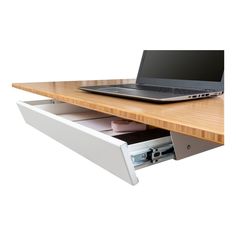 a laptop computer sitting on top of a wooden desk next to a drawer with files in it