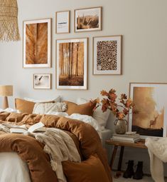 a bed sitting in a bedroom next to pictures on the wall