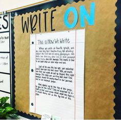 a bulletin board with writing on it in front of a plant and potted plants