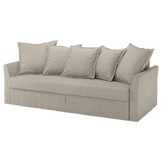 a beige couch with six pillows on the back and one arm folded down to show it's side