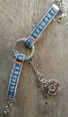 a blue and white dog leash with charms on it's end sitting on a wooden surface