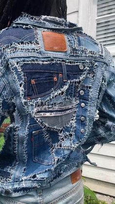 the back of a woman's jean jacket that has been made out of old jeans