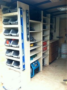 the inside of a garage with shelves and tools