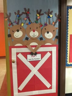 a door decorated to look like a barnyard with reindeers on it and a flag