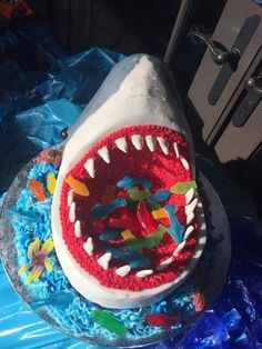 a birthday cake with a shark's teeth on it and decorations around the mouth