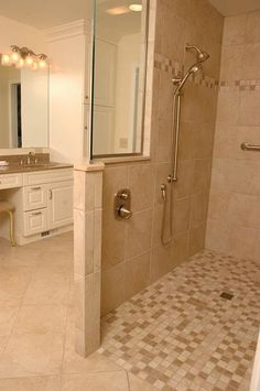 a bathroom with a walk in shower next to a sink