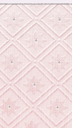 a pink background with white squares and diamonds on the bottom, in shades of light pink