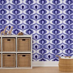 a blue and white wallpaper with an abstract design in the middle, next to baskets