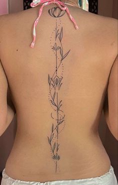 the back of a woman's lower back tattoo