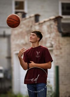 a young man standing in front of a basketball