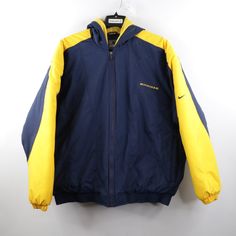 Vintage 90s Nike Mens Xl University Of Michigan Spell Out Hooded Puffer Jacket Mens Jacket Small Hole On The Back Right Sleeve. Has Some Blemishes On The Inner Hood/Collar And Inner Lining. Some Light Blemishes On The Front. Mens Size Xlarge Measurements Are: 29.5 Inches Underarm To Underarm 31 Inches Top To Bottom Blue Nylon Check Out My Other Items In My Store! O1 Blue Nylon Nike Outerwear, Yellow 90s Windbreaker For Winter, Vintage Levi's Blue Outerwear, 90s Blue Sports Track Jacket, 90s Blue Sports Outerwear, 90s Nike, Hooded Puffer Jacket, Nike Mens, University Of Michigan