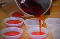 red liquid being poured into plastic cups