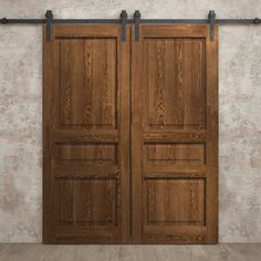 two wooden doors with metal handles in an empty room