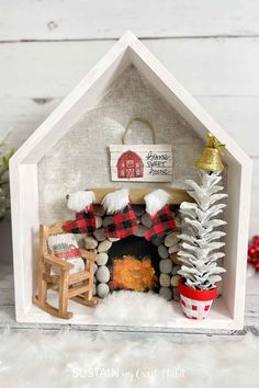 a christmas scene made out of wood and fabric with a small fireplace in the center