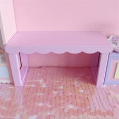 a pink toy bench in the corner of a room