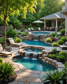 a backyard with a pool and waterfall in the middle